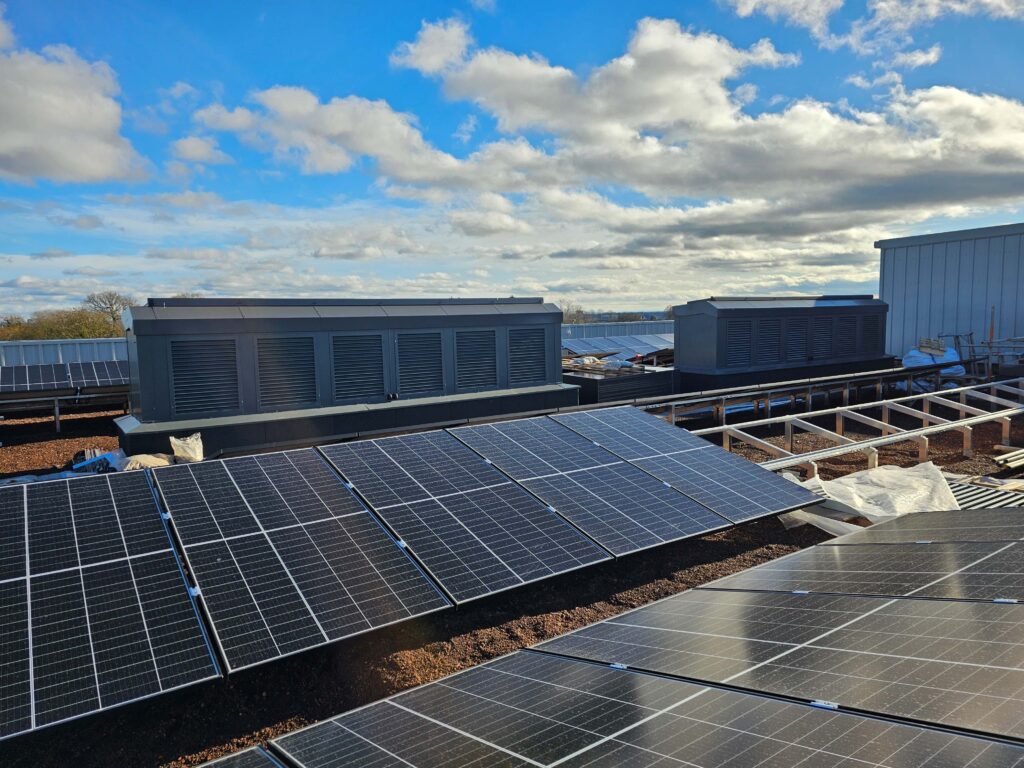 Ventilation stack on a school roof with velux roof lights. 