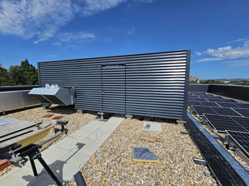 Gallery 100 Dark grey louvre on roof screening plant equipment next to solar panels