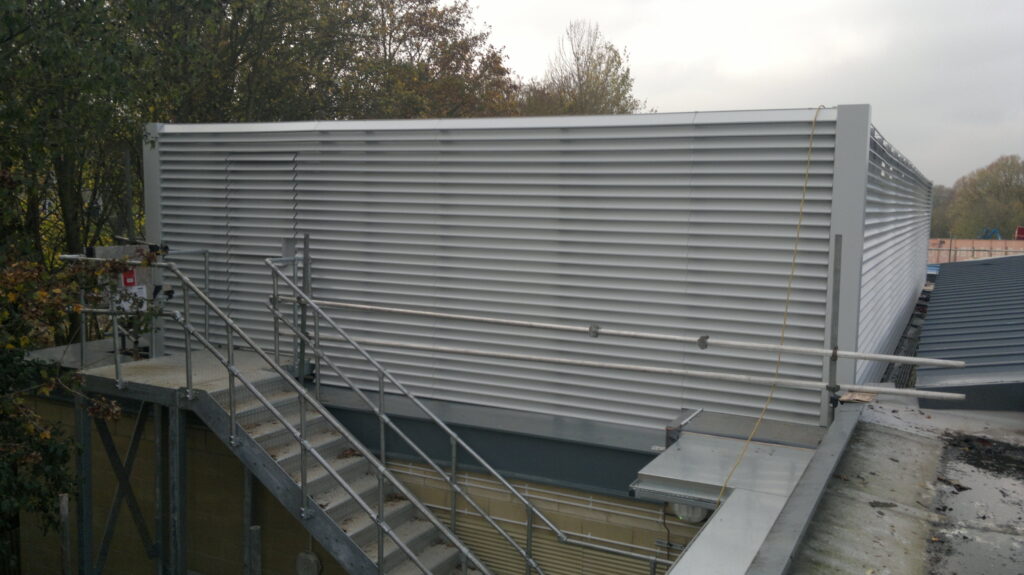 Gallery 101 Light grey painted louvre screens on roof with metal staircase for access to plant machinery